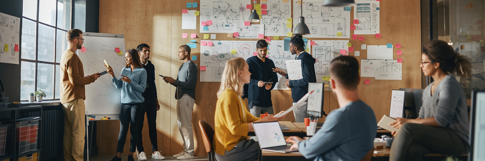 Team entwickelt kreative Strategie am Whiteboard mit Post-its, Roadmaps und Diskussionen im modernen Büro.